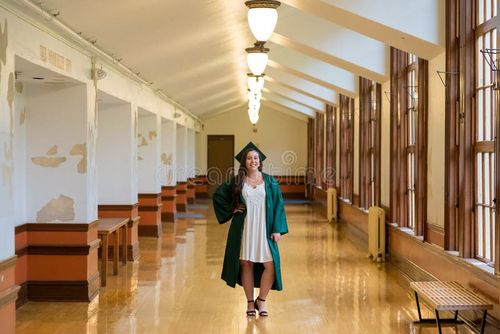 University graduate on her college campus in a cap and gown celebrating graduating from her undergrad bachelor`s degree during the Spring. Bachelor s degree stock images, royalty-free photos and pictures