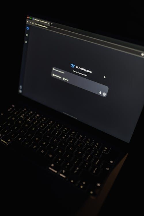Free A dark-themed laptop screen displaying the DeepSeek AI interface, highlighting modern technology. Stock Photo