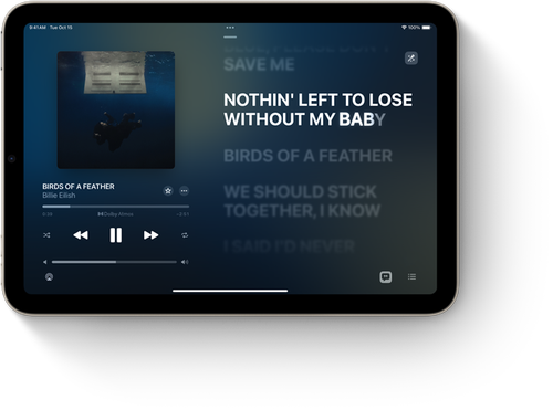 iPad mini, landscape orientation, displaying Apple Music with song lyrics.