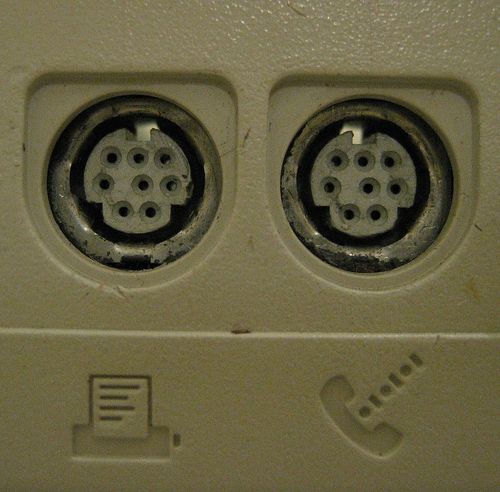 Pair of female Mini DIN-8 connectors used for RS-422 serial ports on a Macintosh LC computer.