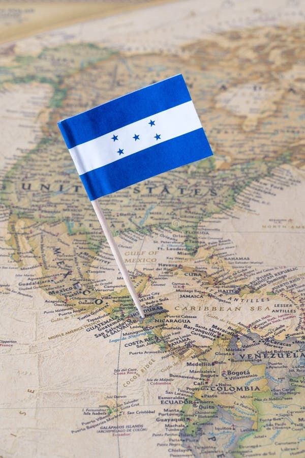Paper flag pin of Honduras on a world map showing neighboring countries. It is a republic in Central America. Concept image. Paper flag pin of Honduras on a world map showing neighboring countries. It is a republic in Central America. Concept image