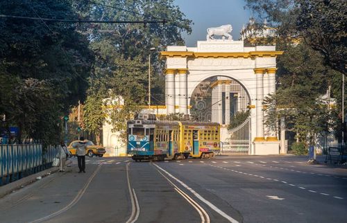 KOLKATA, INDIA -JANUARY 22, 2017: Heritage Kolkata tram passing the front entrance of the historic and Gothic architectural Governor house near Dharamtala Chowringhee area, Kolkata. Kolkata tram stock images, royalty-free photos and pictures