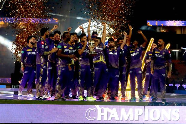 Players of Kolkata Knight Riders celebrate with the trophy after their victory against the Sunrisers Hyderabad in the 2024 IPL Final match between...
