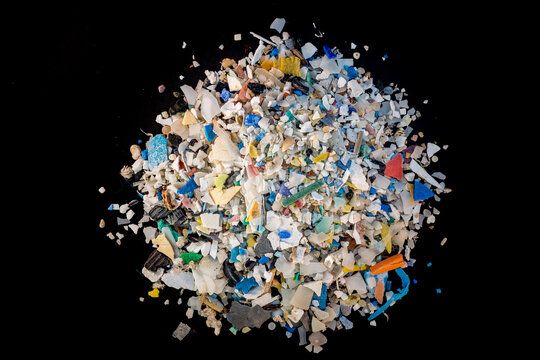 Stock photo of microplastics scattered on a black background