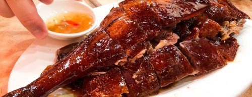 Close-up of golden roast duck with crispy skin