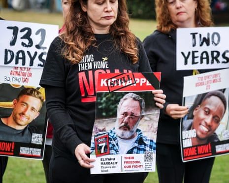 Members of the Australian Jewish community hold placards bearing the portraits of Israelis held hostage in Gaza
