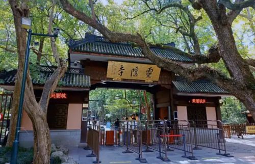 Visitor walking the paths to Lingyin Temple entrance