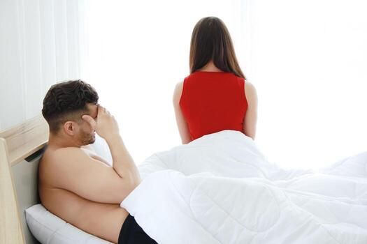 Caucasian lover Couple on the bed unhappy in having sex and have problems in relationship of married life. Wife touchy to her husband. Erectile Dysfunction and Divorce in society concept photo