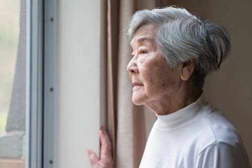 serious asian senior woman in 90s looking out of window - s old stock pictures, royalty-free photos & images