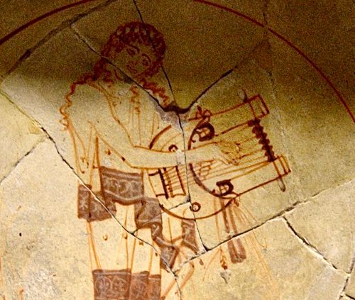 Round-based lyre, a phorminx played by a muse.