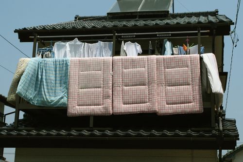 Futons hung out to air on a balcony