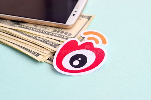 NY, USA - DECEMBER 26, 2019: Weibo paper logo lies with envelope full of dollar bills and smartphone. Weibo app stock images, royalty-free photos and pictures