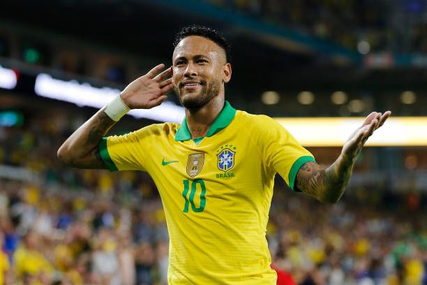 Neymar Jr. #10 of Brazil reacts after assisting Casemiro on a goal against Colombia during the first half of the friendly at Hard Rock Stadium on...