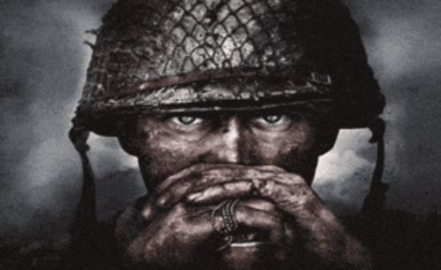 a man in a military helmet covering his mouth
