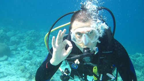 diver giving OK hand signal.