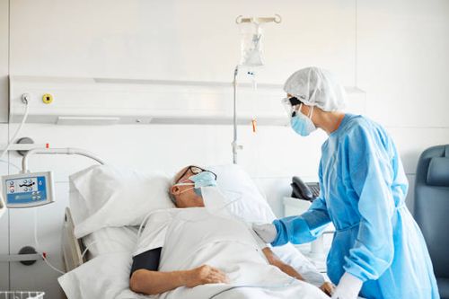 doctor consoling patient in icu during covid-19 - covid 19 sick people stock pictures, royalty-free photos & images