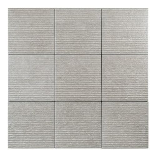 A square, light gray tile displays a textured surface and horizontal grooves, set against a plain, neutral backdrop.