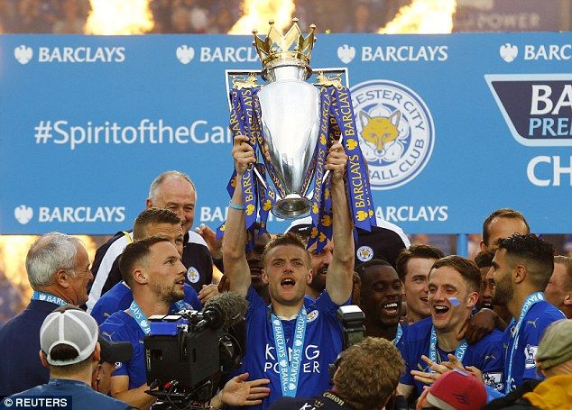 Leicester striker Jamie Vardy lifts the Premier League title high up in the air with his 'brothers'