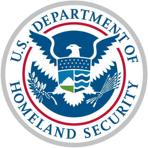Seal of the United States Department of Homeland Security, consisting of an American bald eagle holding a branch and arrows, superimposed by the shield dividing into three sections containing elements that represent the homeland "from sea to shining sea." The top element, a dark blue sky, contains 22 stars representing the original 22 agencies and bureaus that have come together to form the department. The left shield element contains white mountains behind a green plain underneath a light blue sky. The right shield element contains four wave shapes representing the oceans, lakes and waterways alternating light and dark blue separated by white lines.