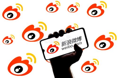 Kazan, Russia - Mar 10, 2022: Smartphone with Weibo chinese microblogging service logo on screen in clenched hand on background of Weibo logos. Weibo app stock images, royalty-free photos and pictures