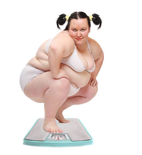 Overweight woman. Overweight woman on a weighing machine. Weight loss concept. pics of a funny fat people stock pictures, royalty-free photos & images