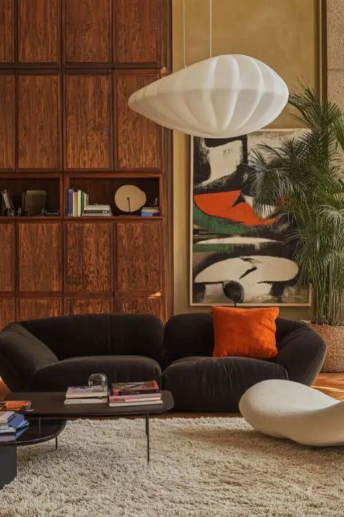 Bold orange accents enliven the modern 70s living room decor.