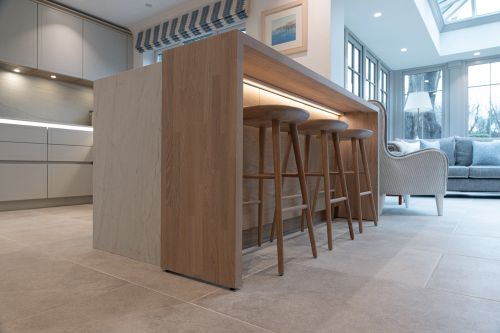 led strip lighting under wooden breakfast bar in kitchen