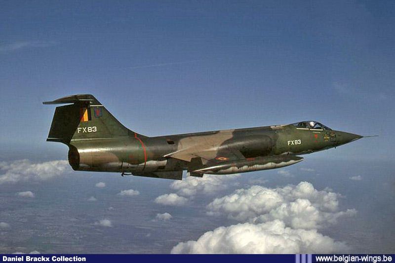 an air force jet flying through the sky above some clouds and land in front of it