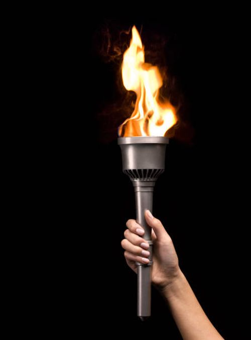 woman holding silver torch, on black background - flaming torch stock pictures, royalty-free photos & images