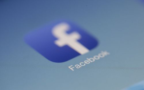 Free Close-up view of the Facebook app logo on a digital screen with blurred background. Stock Photo