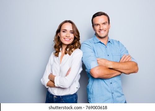 He vs she happy together. Close up portrait of attractive, caucasian, lovely, cute, adult couple in casual outfit looking at camera standing with crossed arms over grey background Stock Photo