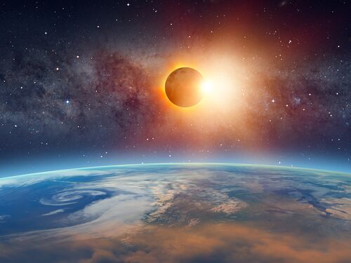Partial solar eclipse above the curvature of the Earth in the foreground.