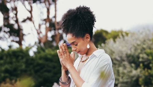 spiritual, woman pray and nature with zen yoga and meditation for peace and wellness. mindfulness exercise, prayer and chakra energy health of a person with balance and calm worship for healing - healing prayer images stock pictures, royalty-free photos & images