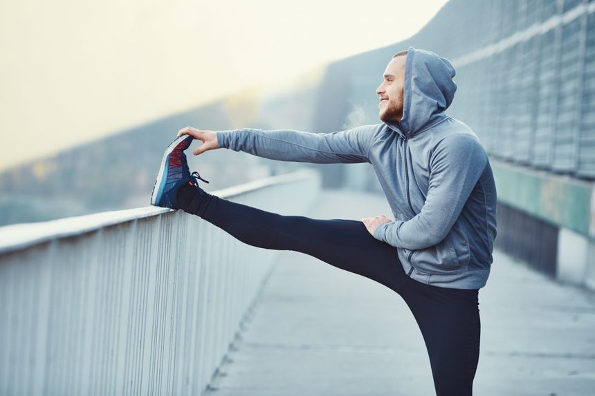 Male,Runner,Doing,Stretching,Exercise,,Preparing,For,Morning,Workout,In