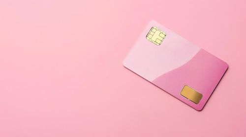 Photo pink credit card on pink background minimalist design