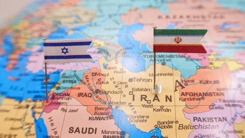 Iran and Israel flags on geopolitical map.