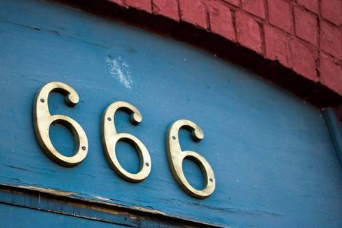 Street address number 666 Closeup of brass street address numbers '666' above a doorway number 666 stock pictures, royalty-free photos & images