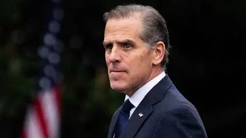 Hunter Biden in a suit looking past the camera