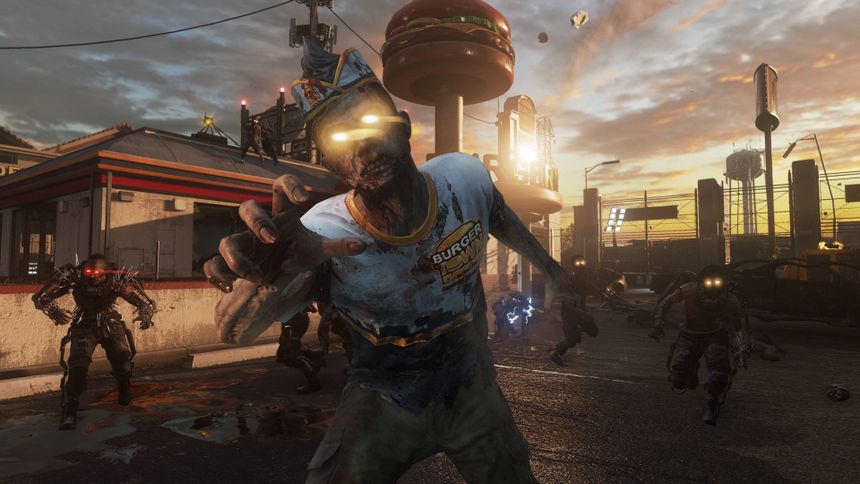 Zombie in burger shirt lunges in ruined fast food plaza at sunset.