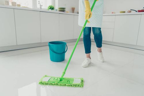 Cropped view of her she house-wife cleansing polishing shine floor parquet tile in modern light white interior indoors Cropped view of her she house-wife cleansing polishing shine floor parquet tile in modern light white interior indoors she stock pictures, royalty-free photos & images