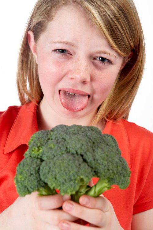 Girl making a face with broccoli FREE Stock Photo, broccoli, girl, healthy eating picture