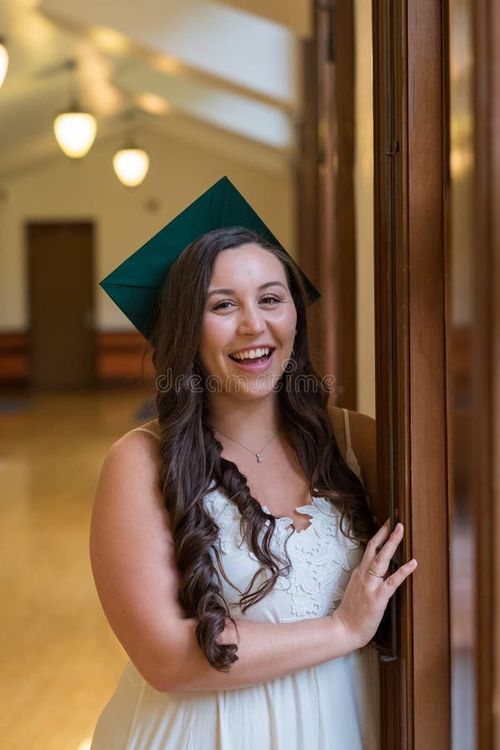 University graduate on her college campus in a cap and gown celebrating graduating from her undergrad bachelor`s degree during the Spring. Bachelor s degree stock images, royalty-free photos and pictures