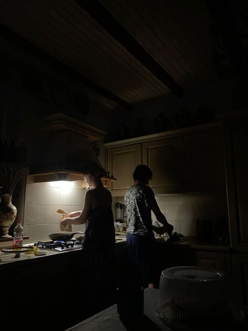 two people standing in a kitchen at night