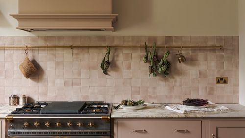 A pink kitchen with a pink square tiles backsplash