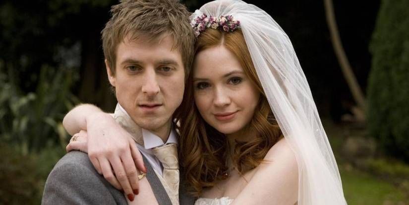 Rory Williams and Amy Pond in their wedding attire, hugging.