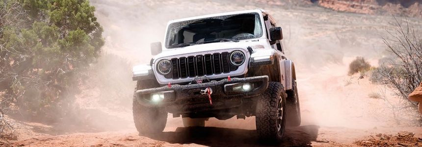 Jeep Wrangler driving through desert terrain showcasing off-road capability near Southern California