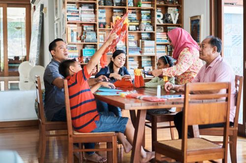 multi-generation family making wau bulan at home - making wau stock pictures, royalty-free photos & images