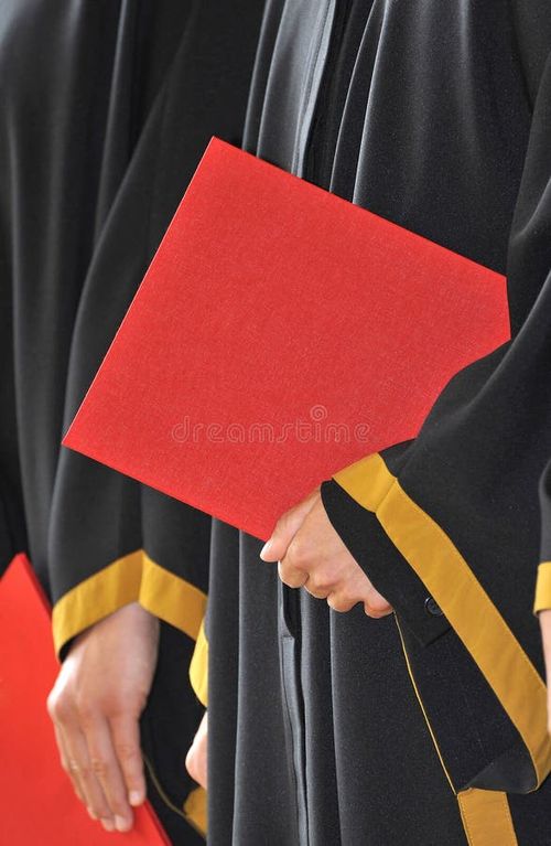 A detail of a figure dressed in a black academic dress holding a red diploma (a diploma with distinction). - hight. Bachelors degree stock images, royalty-free photos and pictures