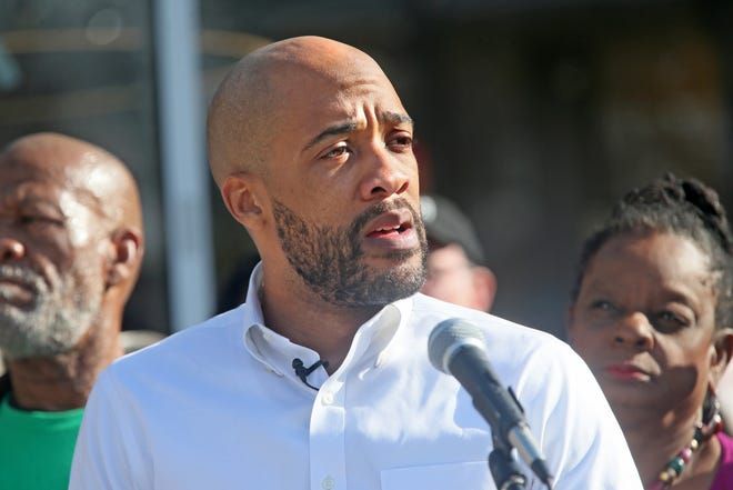 MJS Barnes, nws, adp, 7 of - Mandela Barnes, center, gives his concession speech in the U. S Senate race against incumbent Ron Johnson, while his father Jesse, left and U. S. Congresswoman Gwen Moore, right, listens with others at Sherman Phoenix on Wednesday, Nov. 9, 2022 while family and supporters cheer him on.