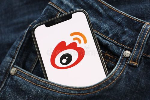 KYIV, UKRAINE - APRIL 1, 2024 Sina Weibo icon on smartphone display screen in jeans pocket. iPhone display with app logo hide in fashionable denims pocket close up. Weibo app stock images, royalty-free photos and pictures